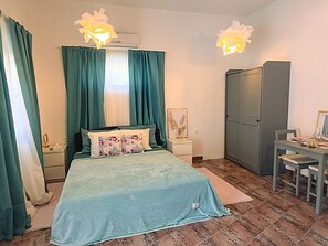 A bedroom with a bed, a nightstand, a desk, and a wardrobe. - Valerija by Interhome (Labin)