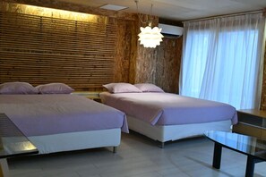A hotel room with two beds, a wooden wall, an air conditioning unit, a glass table, and a large window with curtains. - Rapyuta monthly apartment (Kyoto)