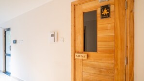 A wooden door with a sign reading 'SAUNA' and a sauna symbol. - Modern 1BR/studio at Wilma Towers,Kilimani near Yaya Center and CJ’s (Nairobi)
