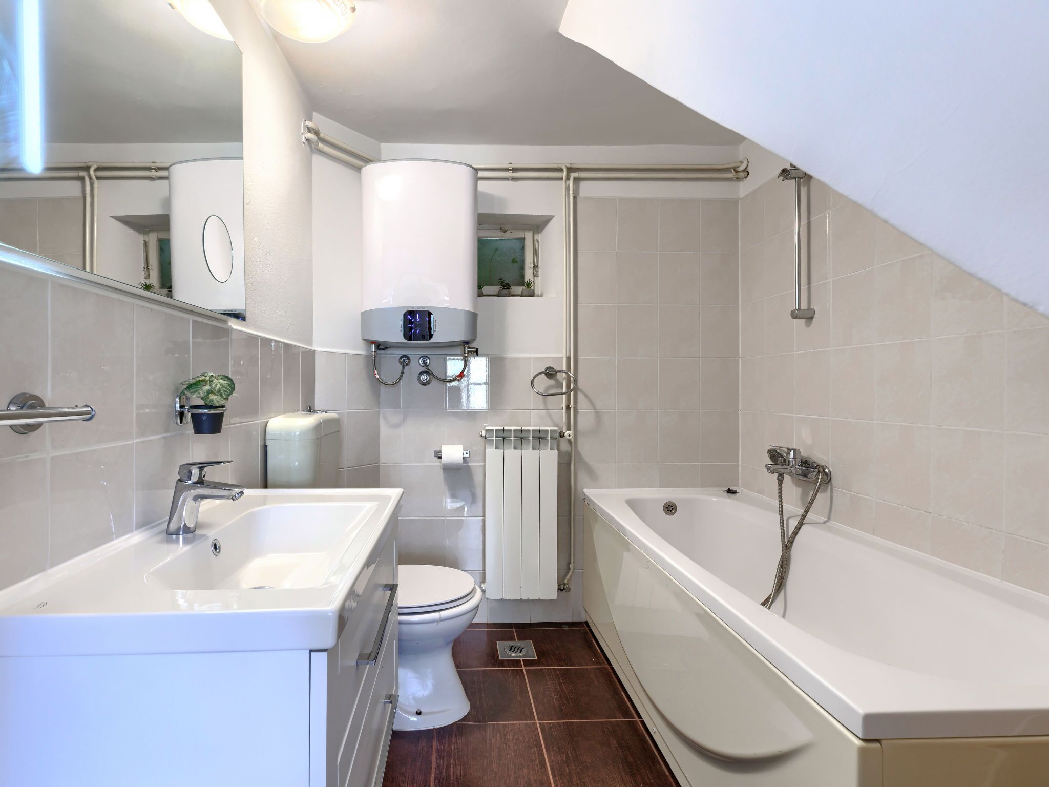 Une salle de bain moderne équipée d’une baignoire, de toilettes, d’un lavabo et d’une douche.