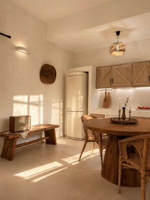A modern kitchen with a central island, wooden cabinetry, and a built-in refrigerator. - Conte Maris II - Sea View Mediterranean Escape (Tragaki)