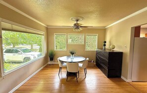 A room with a dining table, chairs, a ceiling fan, and a refrigerator. - Welcome to Harley's House - A cozy 3bed/2bath home in the heart of Enumclaw (Enumclaw)