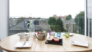 Uma mesa com vista para a cidade através de uma janela.