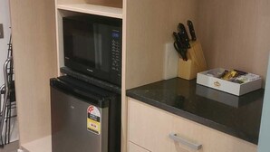A kitchen with a refrigerator, microwave, and knife block. - Wanaka Club Wyndham Resort.  5th-17th September 12 nights Studio King Sleeps 3. (Wānaka)