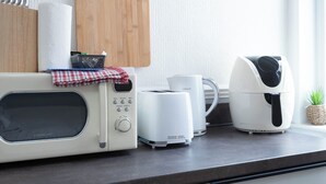 A kitchen with a microwave, toaster, and coffee maker on a countertop. - The Bay Apart-Hotel by Guestz (Morecambe)