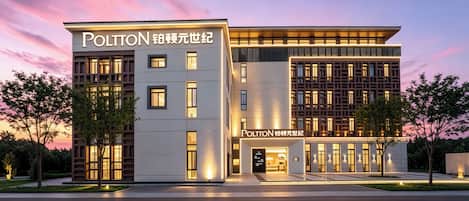 A modern hotel with a prominent entrance and signage.