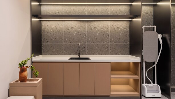 A modern bathroom with a built-in sink, a towel rack, and a shower unit. - homtel by PoLTTON（Xiamen Xiang'an Torch Industrial Park Branch） (Xiamen)