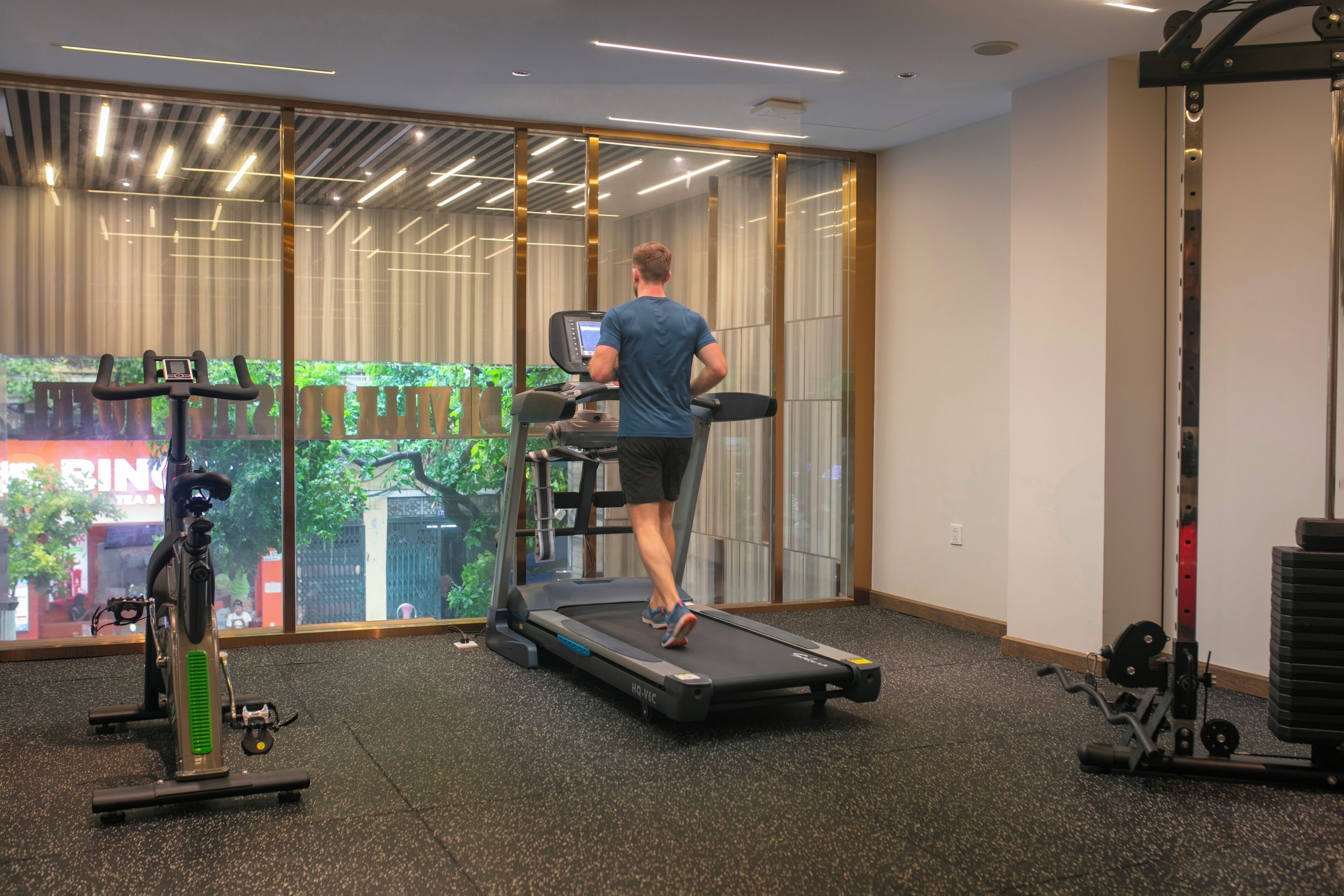 A gym with a treadmill, exercise bike, and weight equipment.