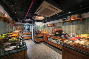 A buffet area with various food options and a coffee station.