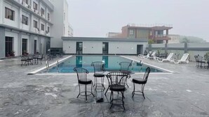 Ein Poolbereich auf dem Dach mit Liegestühlen und einem Pool.