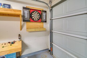 Eine Garage mit Dartscheibe, Werkzeugregalen und einem Sensor-Kasten.