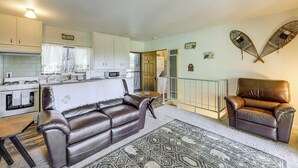 A compact living space with a kitchenette, a sofa, a chair, and a patterned rug. - Deck & Mtn Views! Woodsy Haven in Running Springs (Running Springs)