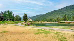 A lakeside view with a dirt path leading to a wooden cabin. - Keystone Lakefront Retreat! Pool & Hot Tub Access (Keystone)