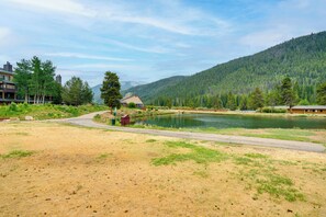 A lakeside view with a dirt path leading to a wooden cabin. - Keystone Lakefront Retreat! Pool & Hot Tub Access (Keystone)