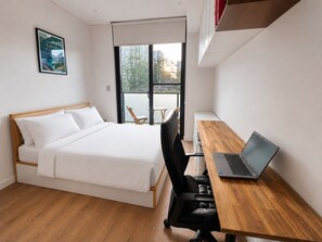 A bedroom with a bed, a desk with a laptop, a chair, and a window with a view of buildings and trees. - Modern 2BDR Retreat walk to Metro and Macquarie (Macquarie Park)