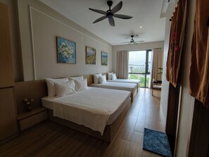 A hotel room with two beds, a ceiling fan, artwork on the wall, and a view through the window. - Ikigai Wellness Ba Vi Retreat (Hanoi)
