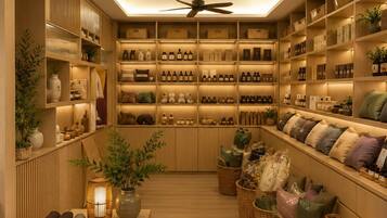 A well-organized storage room with shelves containing various bottles and boxes, a ceiling fan, and wicker baskets with cushions.