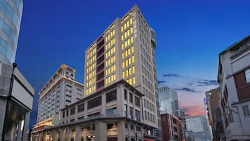 A multi-story hotel with a modern design, featuring a prominent entrance and a large balcony area.