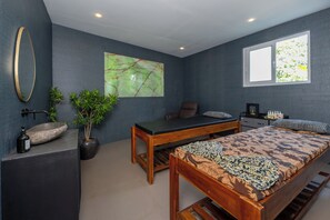 A modern bedroom with a bed, a desk, a chair, a large window, and a wall-mounted mirror. - Boutique Hotel Villa Kaui collections (Ubud)