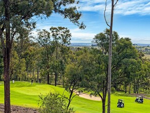 A golf course with trees, a clear sky, and distant hills. - Vilamoura - 2-Storey Villa within Cypress Lakes Resort (POKOLBIN)