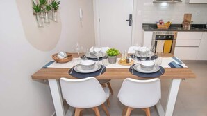 Una mesa de comedor dispuesta con platos, vasos y un centro de mesa.