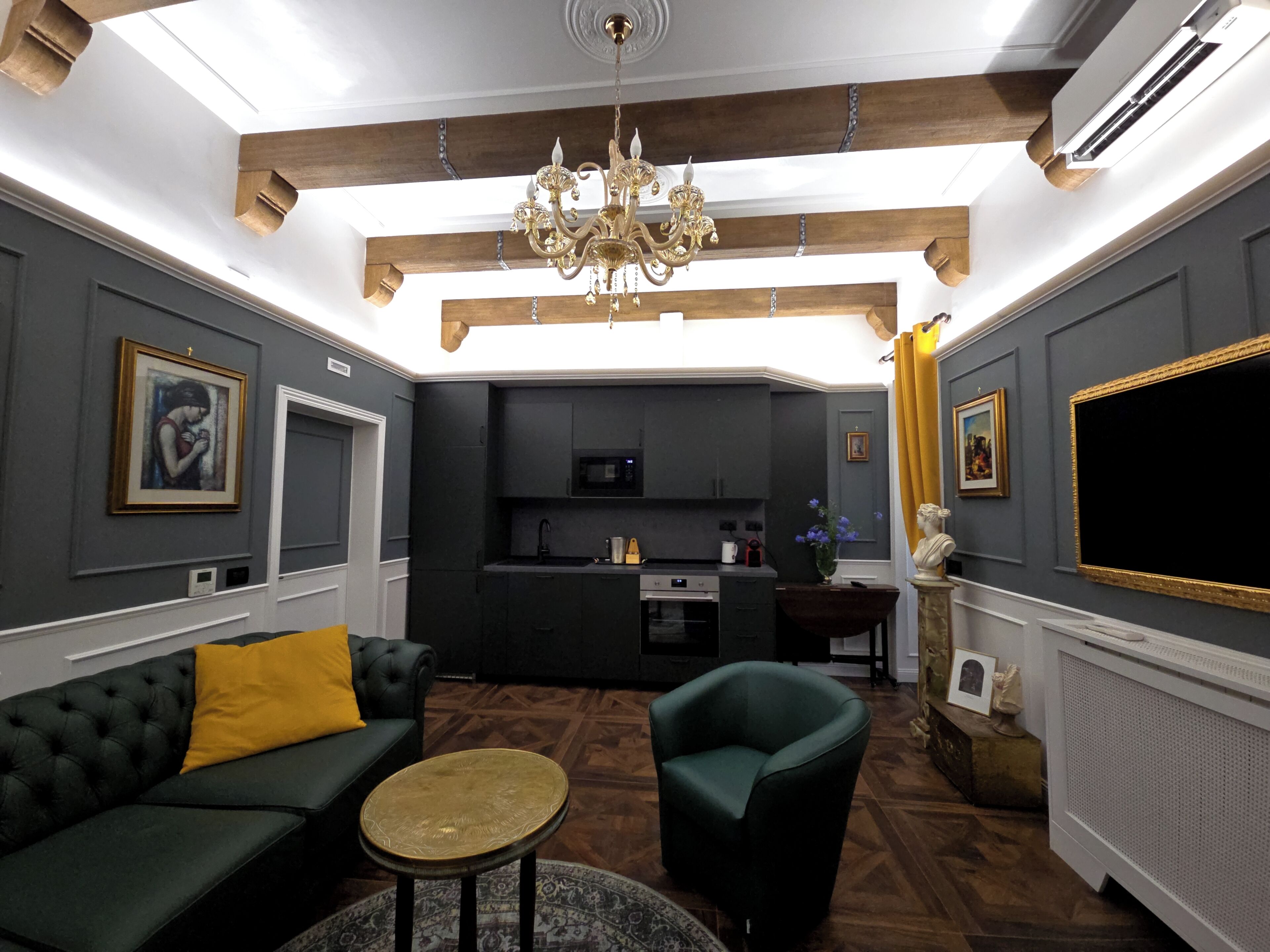Una sala de estar moderna con un sofá, un sillón y una pequeña mesa redonda.