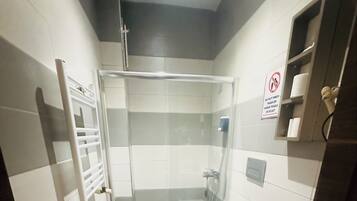 Shower, hair dryer, slippers, towels