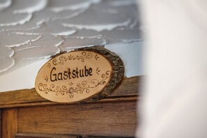 A wooden sign with the word 'Gaststube' on it.
