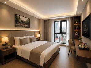A hotel room with a large bed, bedside tables, a desk, a chair, a window with curtains, a wall-mounted TV, and a framed picture on the wall.
