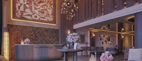 A hotel lobby with a reception desk, seating area, and a large abstract artwork on the wall.