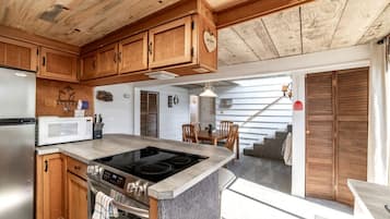 A kitchen with wooden cabinets, a built-in stove, and a microwave.
