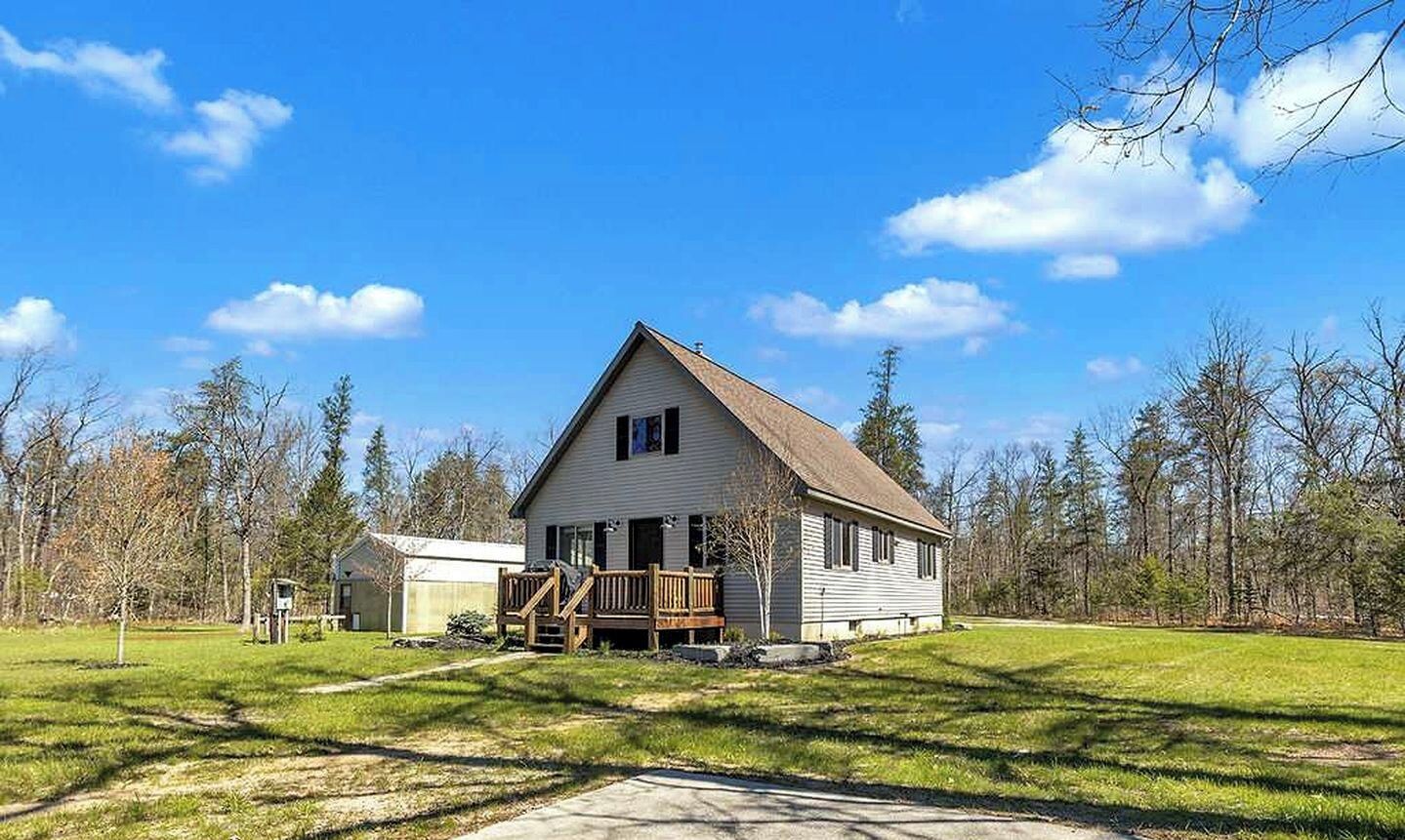 A single-story house with a front porch, a small attached garage, and a lawn in front.