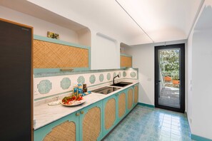 A kitchen with a sink, countertop, and cabinets. - Estate4home - Villa Nerea (Massa Lubrense)