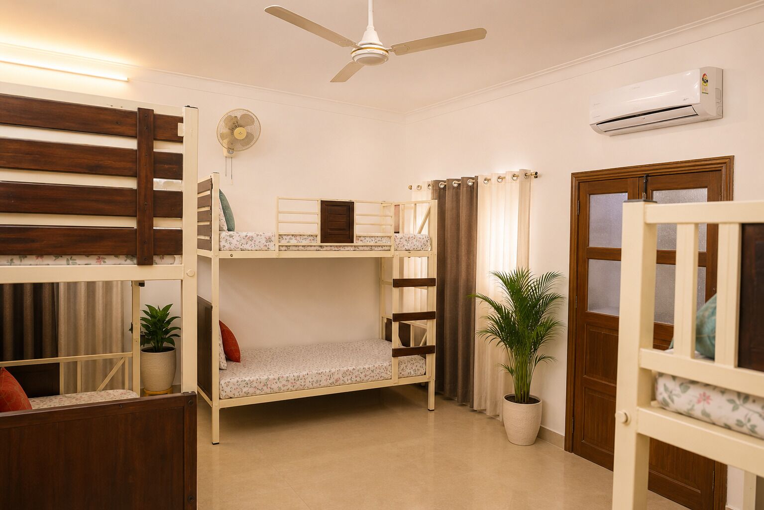 A bunk bed room with a ceiling fan, an air conditioner, and a potted plant.