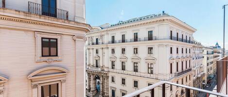 A multi-story building with classical architecture, featuring balconies and a central entrance with columns.