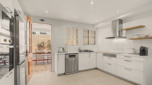 A modern kitchen with white cabinetry, stainless steel appliances, and a dishwasher. - Holiday Home 'Villa da Pena' with Jacuzzi and Air Conditioning (Funchal)