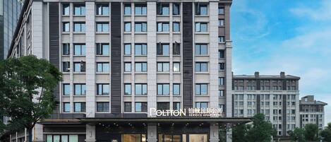 A multi-story building with a service apartment labeled 'POLTON SERVICE APARTMENT' on the ground floor.