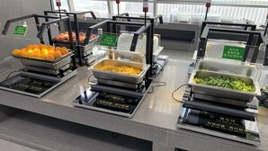 A buffet area with multiple trays of food including fruits, vegetables, and other dishes. -  Nestory Residence - Foshan Lecong Furniture Market  (Foshan)