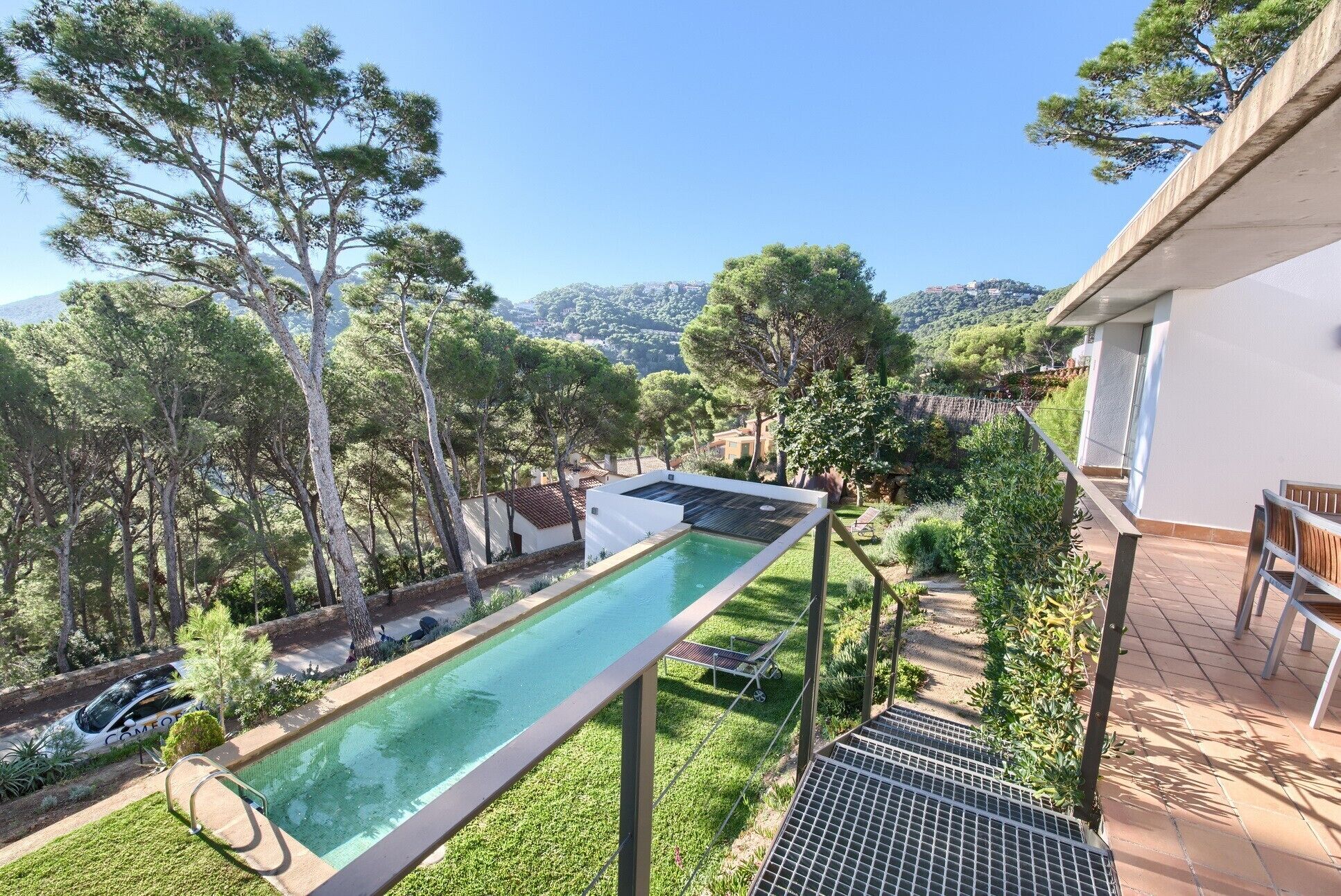 A rooftop pool with a view of a mountainous landscape.