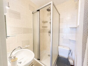 A modern bathroom with a glass-enclosed shower, a white sink, and a toilet. - Cozy studio, pets and parking - 3 guests (Sète)