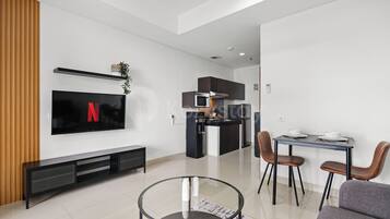 Apartment, 1 Bedroom, Balcony, City View | Living area | 55-inch Smart TV with cable channels, Netflix, streaming services
