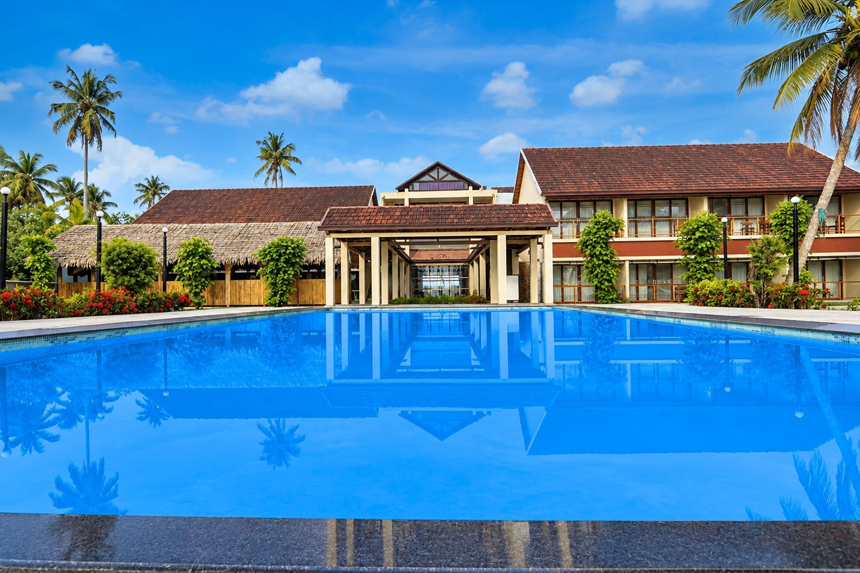 A swimming pool with a clear view of a hotel building in the background.