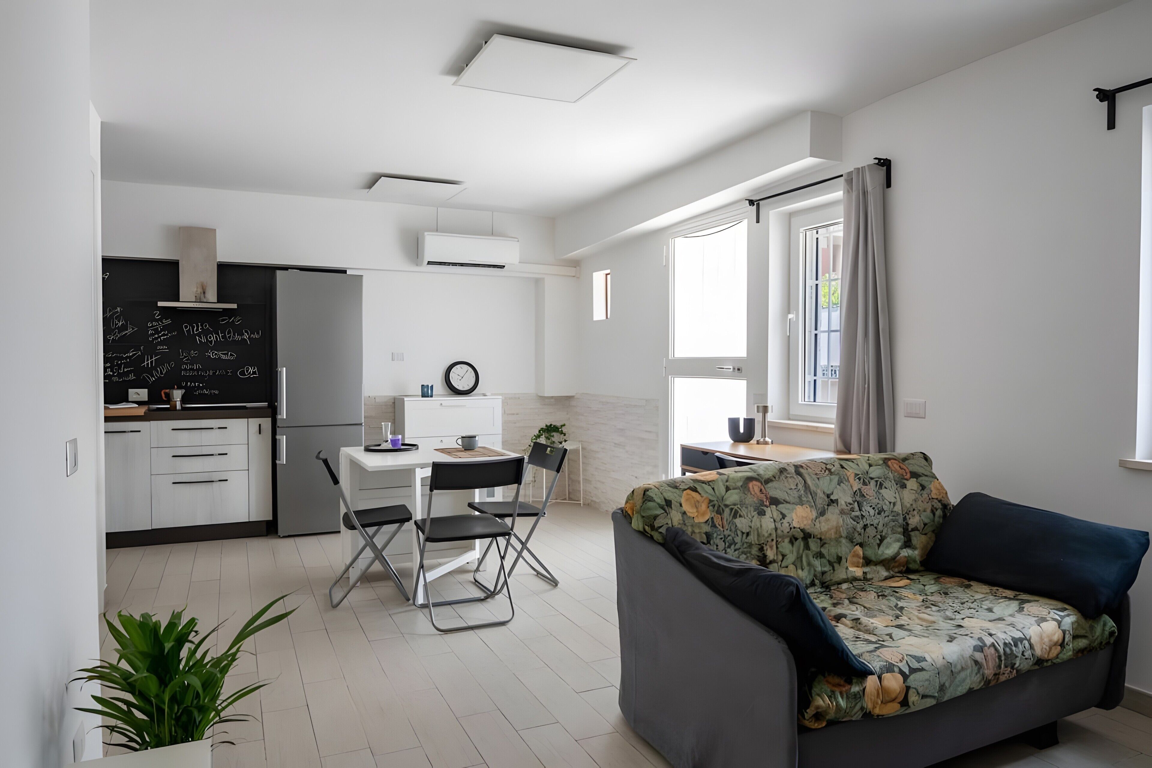 A modern apartment with a kitchen, dining area, and living room.