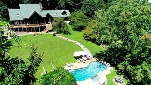 A large house with a swimming pool and a deck area.