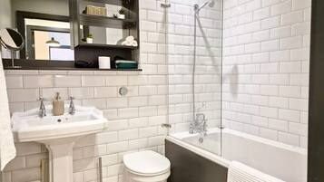 Shower, hair dryer, towels, toilet paper