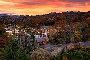A rural landscape with a small house surrounded by trees and a valley below. - Luxury Gatlinburg Cabin with Game Room & Hot Tub near Trolley in Gatlinburg, Tennessee (Gatlinburg)