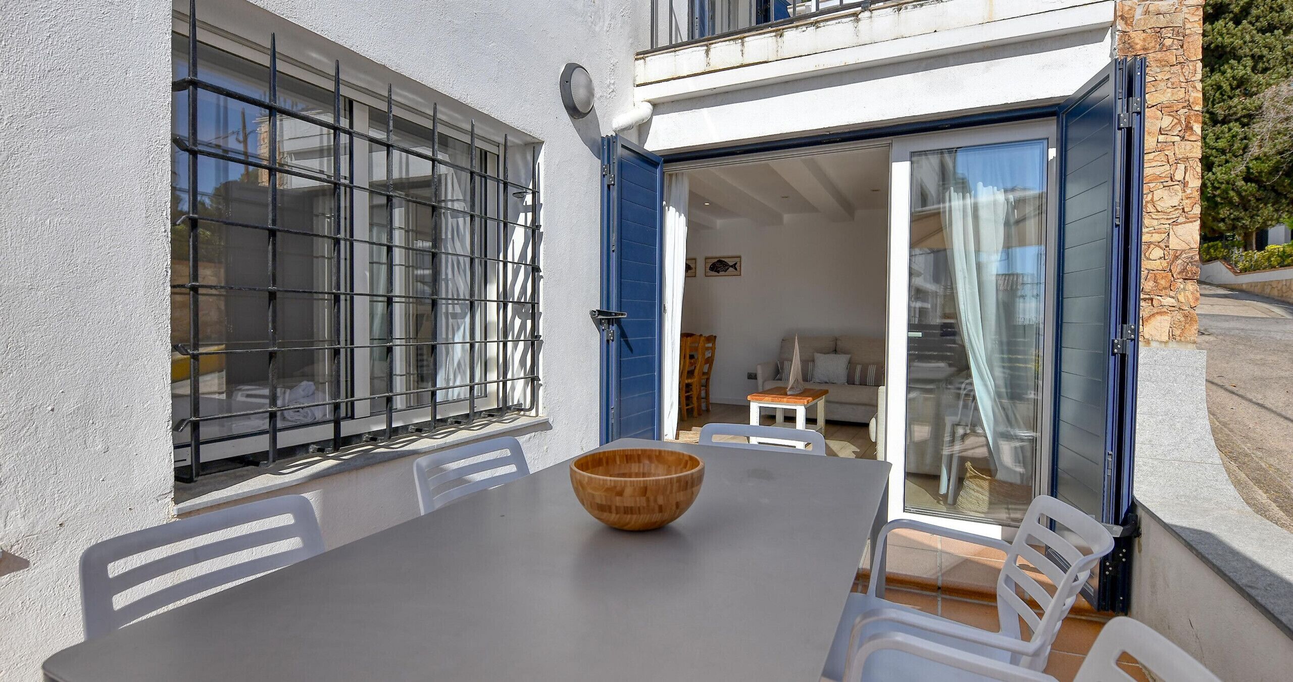 A dining area with a table, chairs, and a wooden bowl.