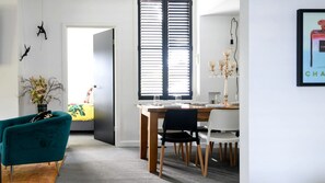 A modern dining area with a wooden table, chairs, and a chandelier. - Incredible Pet Friendly Vacation Rental in Daylesford, Victoria (Daylesford)