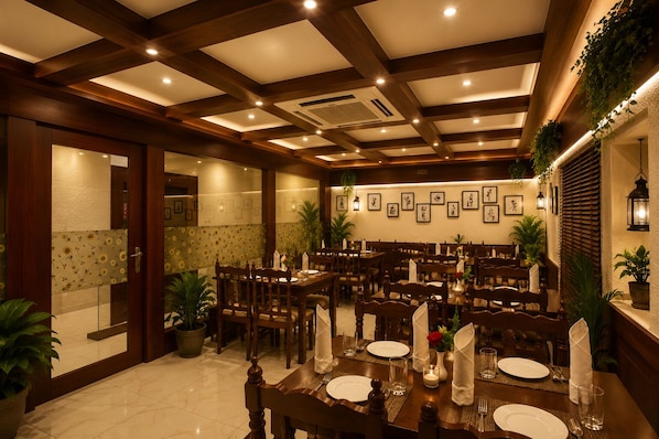 A dining area with wooden tables and chairs, a tiled floor, and framed pictures on the walls.