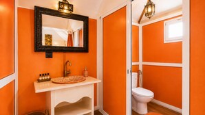 A bathroom with a white sink, a mirror, and a toilet.